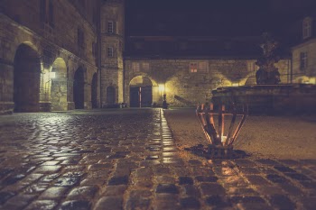 Brown Outdoor Lamp Beside Gray Stone Pavement during Nighttime