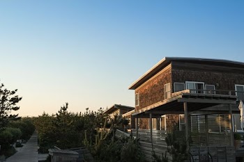 brown painted house with brown wooden fence