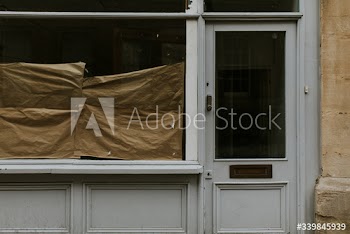 Brown paper behind the closed shop glass window during coronavirus pandemic