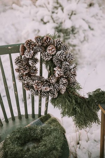 brown pine cone wreath hanged on chair
