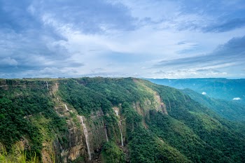 Brown Rock Cliff and Green Trees