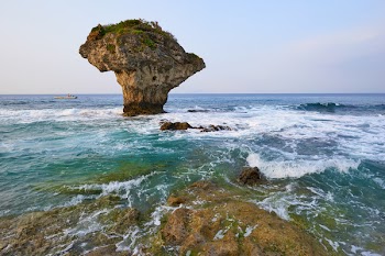 Brown Rock Formation Above Body of Water