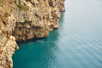 Brown Rock Formation on Body of Water