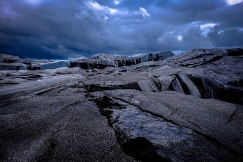 brown rock formation under black sky during daytime