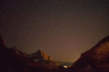 brown rock formation under starry night