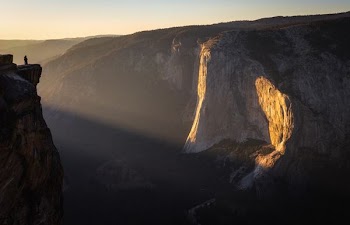 brown rock formation with sun rays at golden hour