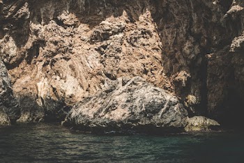 Brown Rock Near Body of Water