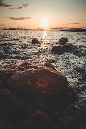 Brown Rocks In Body of Water
