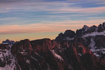 brown rocky mountain under blue cloudy sky photo
