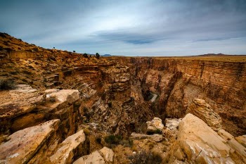 brown rocky mountain under cloudy sky