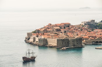 Brown Sailing Ship Near Building