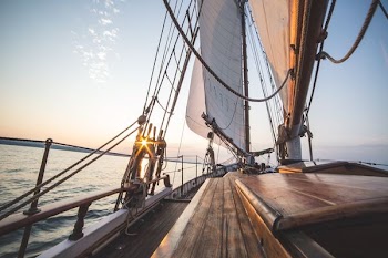 brown ship sailing on sea during daytime