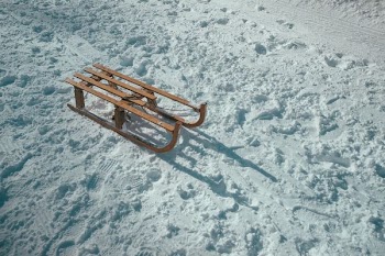 brown sled on snow during daytime
