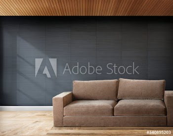 Brown sofa in a room with gray walls