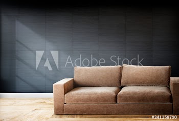 Brown sofa in a room with gray walls