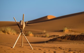 Brown Stone on Tripod Sticks at a Desert