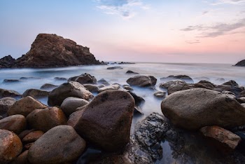Brown Stones on Body of Water Wallpaper