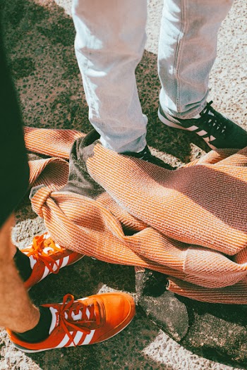 Brown Textile Near Two Person's Feet