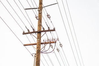 brown transmission tower with cables