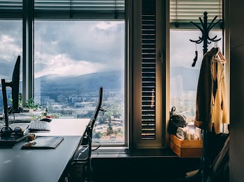 Brown Trench Coat on Wooden Rack