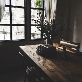 Brown Typewriter on Top of Brown Table