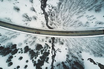 brown vehicle travelling on road during daytime