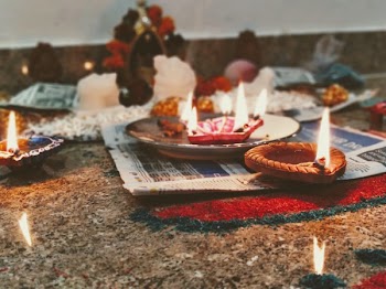 Brown Votive Candle on Newspaper
