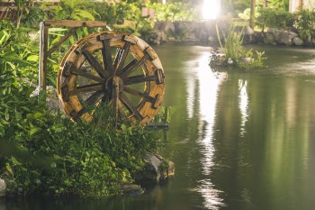 Brown Water Wheel Near Body Of Water