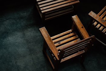 brown wooden armchairs on floor tiles