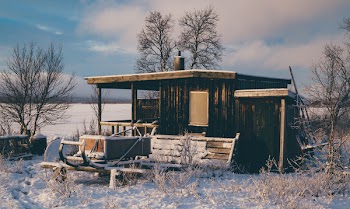 Brown Wooden Barn Surrounded by Snow