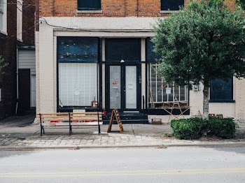 brown wooden bench in front of black store