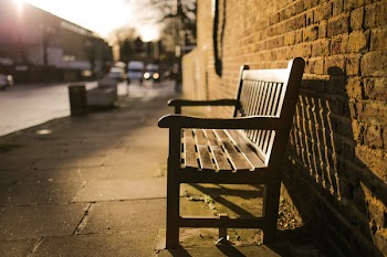 Brown Wooden Bench on the Side of the Road