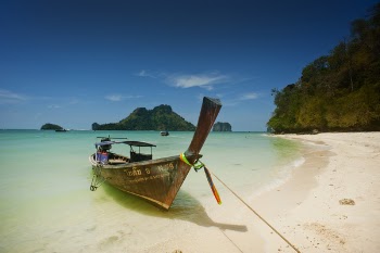 Brown Wooden Boat Beside Body of Water