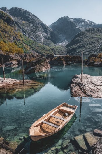 Brown Wooden Boat on Lake Near Mountain · Free Stock Photo