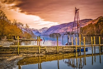 Brown Wooden Bridge Near Mountains and Body of Water