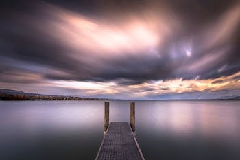 brown wooden dock near body of water