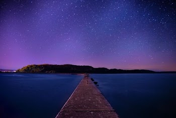 brown wooden dock under night sky