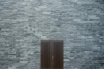 Brown Wooden Door On A Flat Bricked Wall
