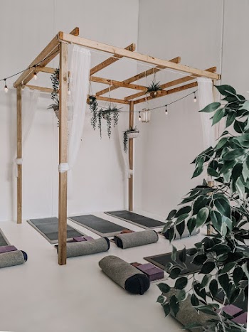Brown Wooden Framed Canopy Above Yoga mat