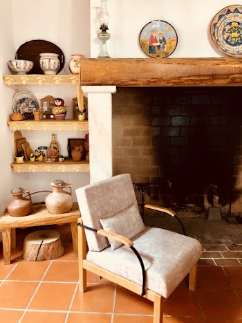 Brown Wooden Framed Padded Gray Armchairs Near the Fireplace