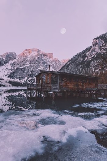brown wooden house beside the mountain