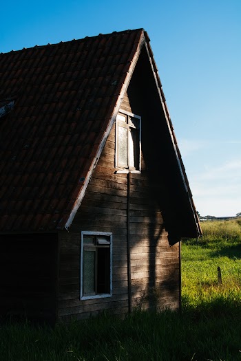 Brown Wooden House Near Grass Field