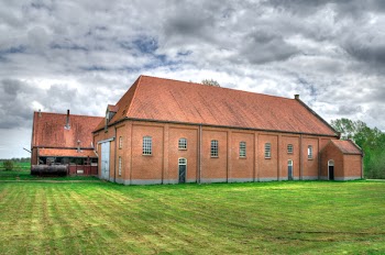 Brown Wooden House Surrounded by Green Grass