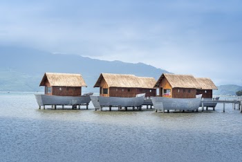 Brown Wooden Houses at Middle of Sea