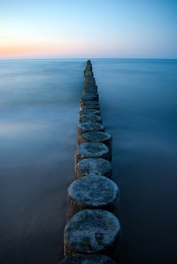 Brown Wooden Poles on Sear Water during Daytime