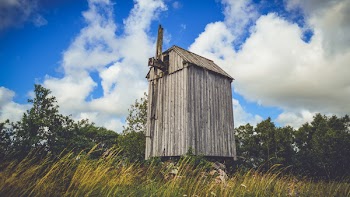 Brown Wooden Shed and Grass Field
