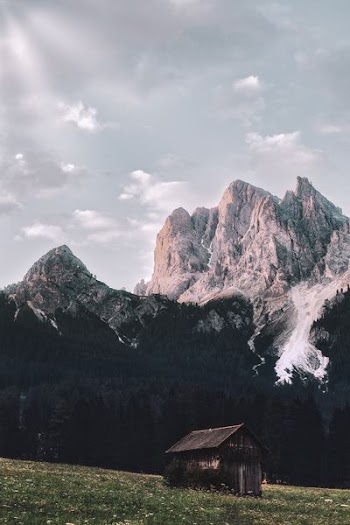 brown wooden shed near mountain