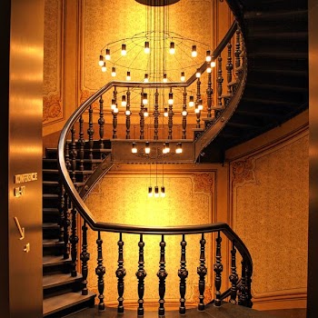 Brown Wooden Stairs and Chadelier