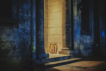 brown wooden stool beside concrete pillar
