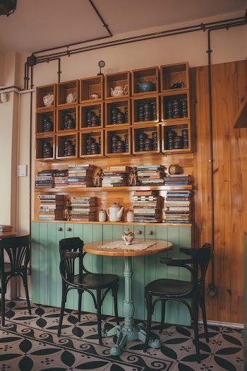 Brown Wooden Table With Two Black Chairs Inside Room
